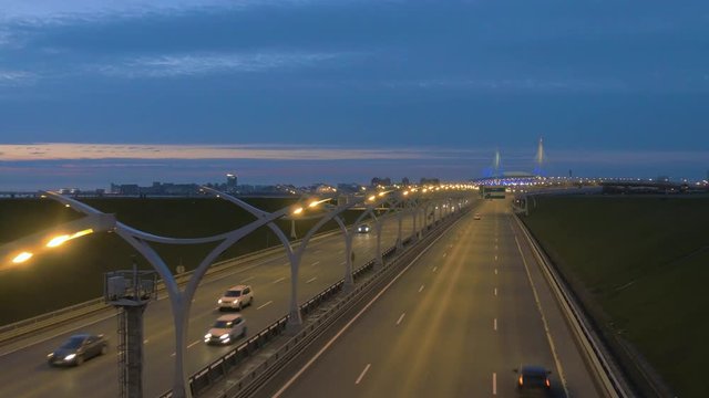 Night highway road in Saint Petersburg, 4k urban footage. Road in Russia. Colorful car headlights and flashing traffic lights. Western High-Speed Diameter road