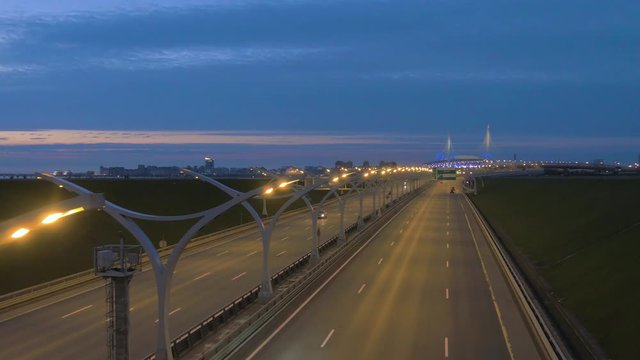 Night highway road in Saint Petersburg, 4k urban footage. Road in Russia. Colorful car headlights and flashing traffic lights. Western High-Speed Diameter road
