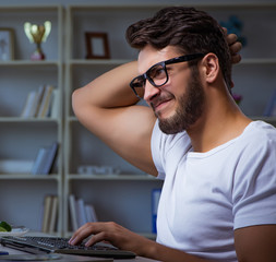 Young man staying late in office to do overtime work