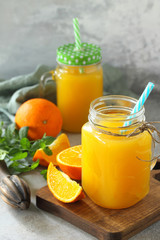 Refreshing juice made of orange, cold drink on a stone or slate background. Concept fresh vitamins. Rustic style. Free space for your text.