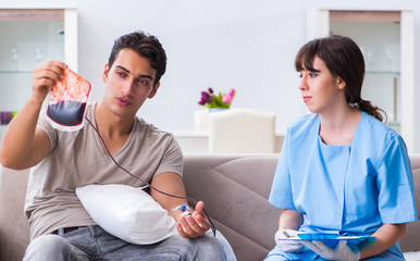 Patient getting blood transfusion in hospital clinic