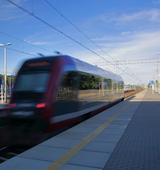 Fototapeta na wymiar train in motion, in soft focus, leaves platform