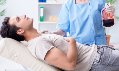 Obraz premium Patient getting blood transfusion in hospital clinic