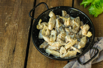 chicken meat with mushrooms in a creamy sauce - snacks. healthy food and menu. copy space