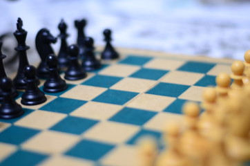 Chess game with focus at the center black pawns and unfocused on the rest of the scene