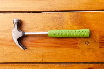 A hammer is laying on a wooden surface
