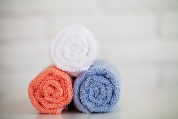 Obraz na płótnie Canvas Spa. Colored Cotton Towels Use In Spa Bathroom. Towel Concept. Photo For Hotels and Massage Parlors. Purity and Softness. Towel Textile