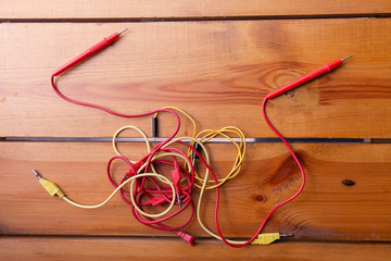An assortment of cables are laying on a wooden surface
