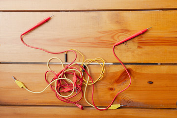 An assortment of cables are laying on a wooden surface