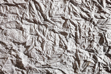 Paper background, grey and wrinkled, looks like concrete 