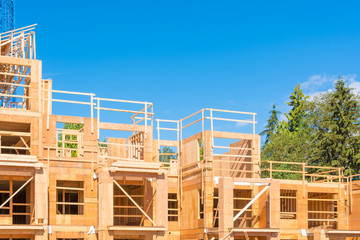 New condo building under construction on blue sky and trees background
