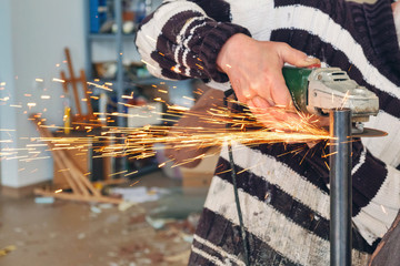 worker working with hand grinder