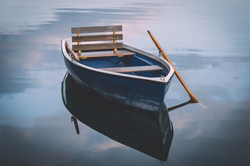 Image of wooden rowing boat on lake - Powered by Adobe
