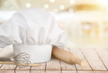 Fototapeta na wymiar Chef hat and kitchen utensils on white background