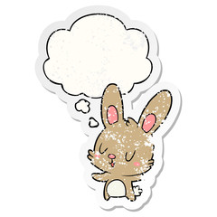 cute cartoon rabbit and thought bubble as a distressed worn sticker