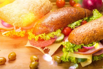Fresh tasty sandwiches on wooden background