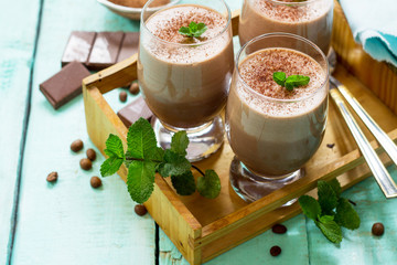 Homemade chocolate-nut mousse on the kitchen wooden background. Free space for your text.