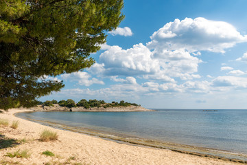 Landscape with beach, the sea and the clouds in the blue sky