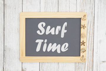 Fototapeta premium Surf time text on a chalkboard with nautical objects