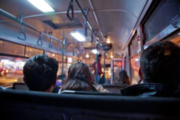 Obraz na płótnie Canvas People in old public bus, view from inside the bus . People sitting on a comfortable bus in Selective focus and blurred background. s the main mass transit passengers in the bus.
