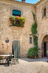 Italian Villa with Balcony House with Courtyard,  Red Flowers, and Ivy