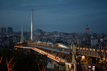 Night view of the metro bridge through the Golden Horn and the Galata Tower in Istanbul, Turkey