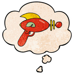cartoon ray gun and thought bubble in grunge texture pattern style