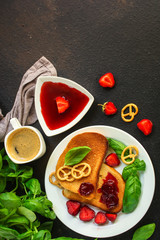Toast, strawberry jam and coffee - breakfast (tasty snack with basil, dessert). food background. top view. copy space