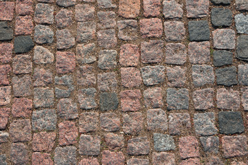 Surface texture paving stone of red granite.