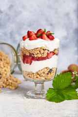 Healthy dessert with granola, yogurt and strawberries