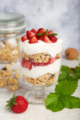 Healthy dessert with granola, yogurt and strawberries