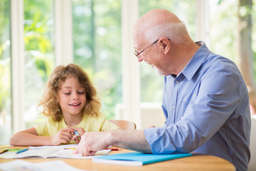 Man and his grandchild doing homework after school