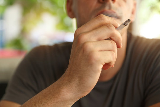 Man enjoying smoking cigarette outdoor
