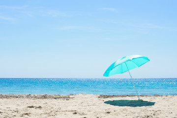 Sun umbrella on the sandy beach.