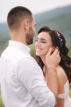 Close up portrait of beautiful couple in mountains. Happy woman with man. Elegant female with her husband