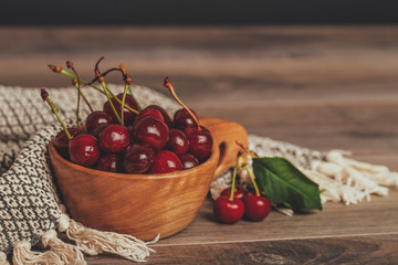 Fresh sour cherries in wooden bowl