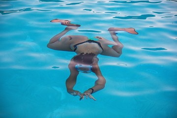 Under Water Swimming. Young girl swimming under water looking frog like . Stock Image.