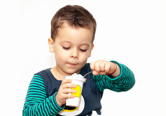 little kid eating yogurt on white background