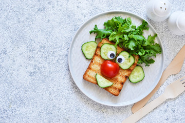 Cheerful clown. Sandwich for children for breakfast. View from above.
