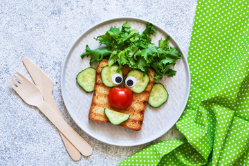 Cheerful clown. Sandwich for children for breakfast. View from above.