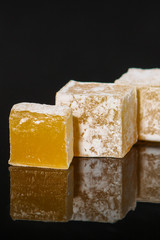 lokum Turkish delight, sweets on a black background (dessert sweets). food background. top view. copy space