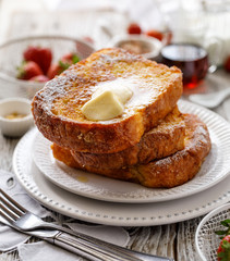 French toast, warm French toast made of sliced brioche with fresh butter, sprinkled with powdered sugar. Delicious, traditional breakfast