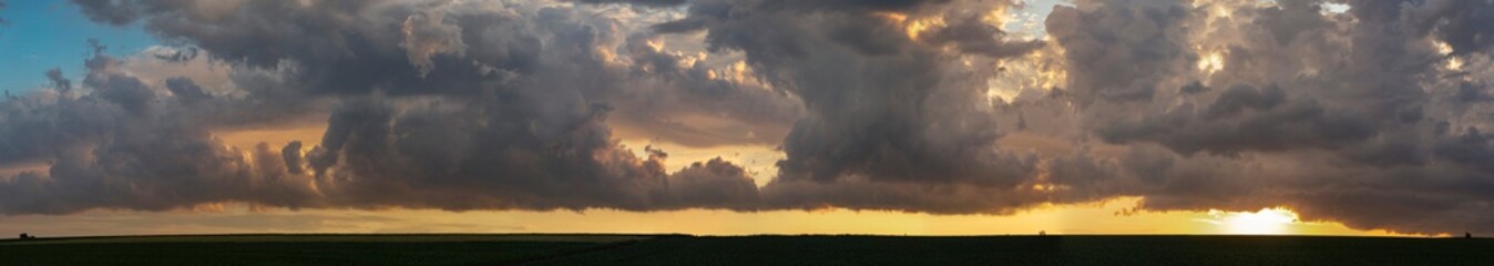 Leaden, storm clouds covered the sunset. Cumuliform cloudscape on blue sky. The terrain in southern Europe. Fantastic skies on the planet earth. Tragic gloomy sky.