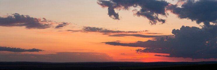 Leaden, storm clouds covered the sunset. Cumuliform cloudscape on blue sky. The terrain in southern Europe. Fantastic skies on the planet earth. Tragic gloomy sky.