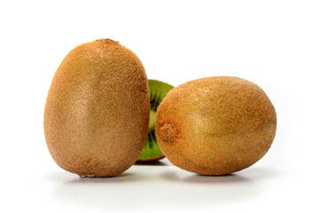 Two fresh ripe whole kiwi fruits isolated on white background with shadows, closeup.