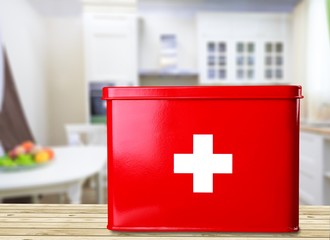 First aid kit with  on wooden table