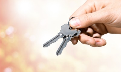 Keys in hand ,close up on background
