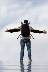 Young And Slim Man Observing From Above With Sky Background, Dressed In Casual Clothes