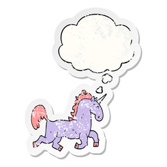 cartoon unicorn and thought bubble as a distressed worn sticker