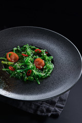 Chuk salad on a black plate